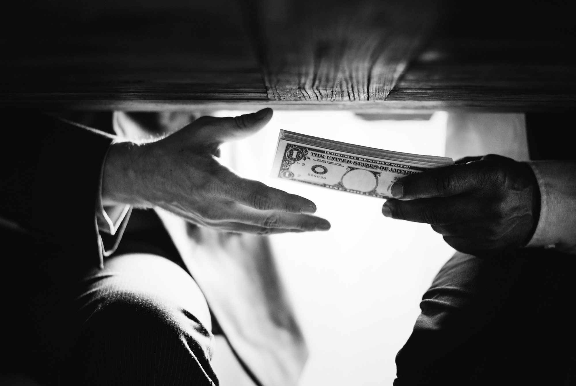 passing money under the table as bribe, an example or white-collar crime