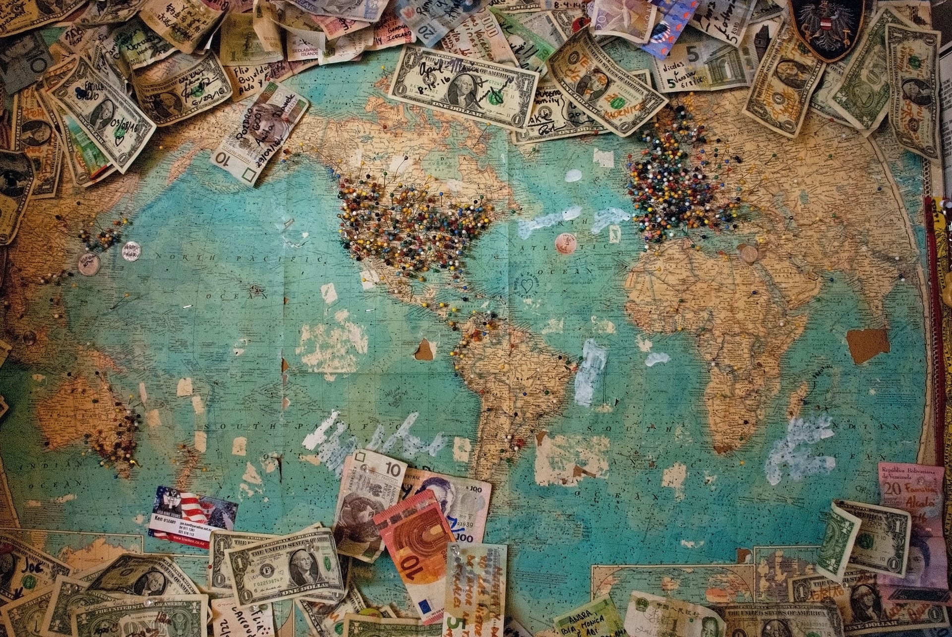 world map with money all around
